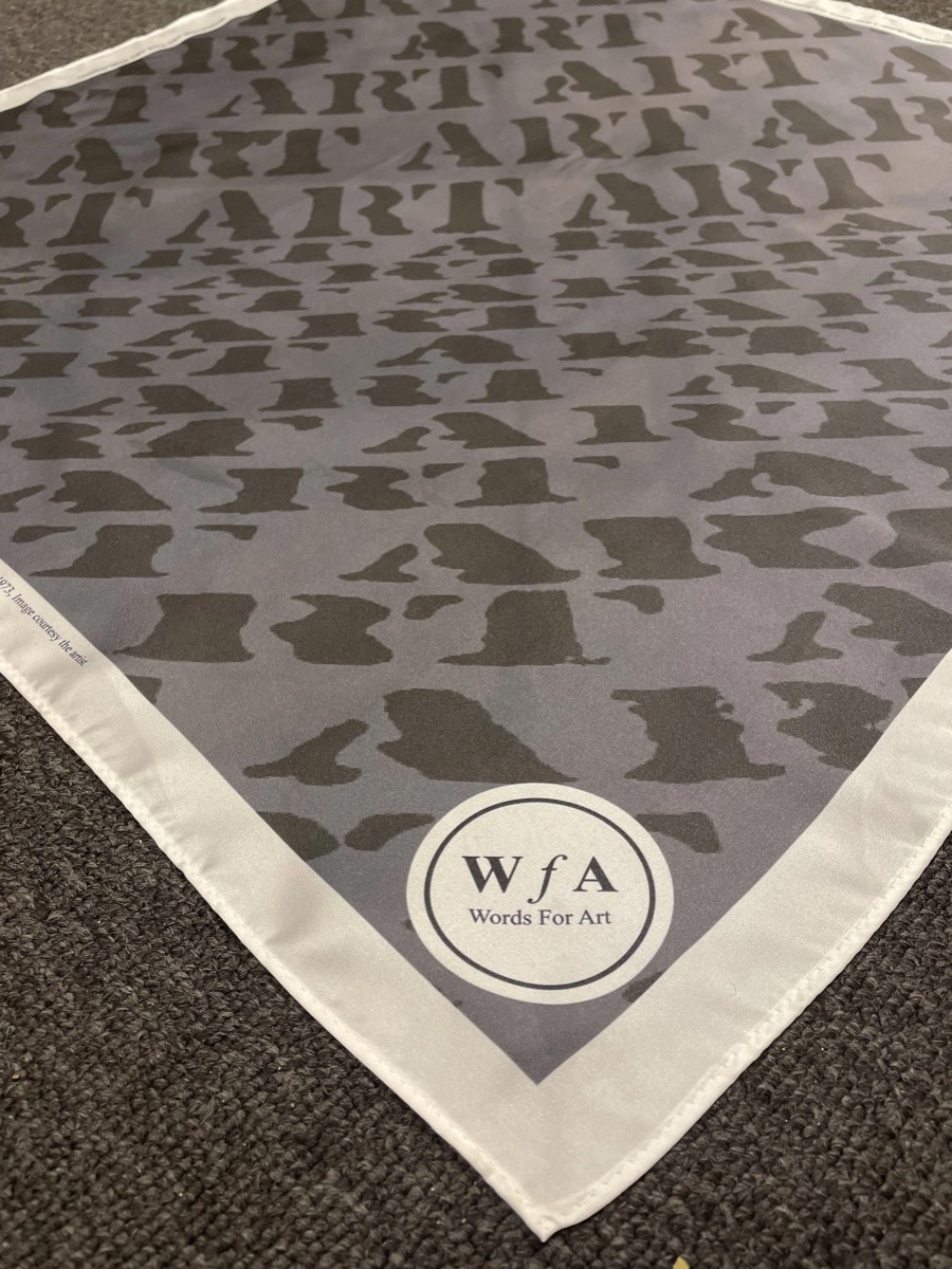 The scarf folded, with the Words For Art roundel