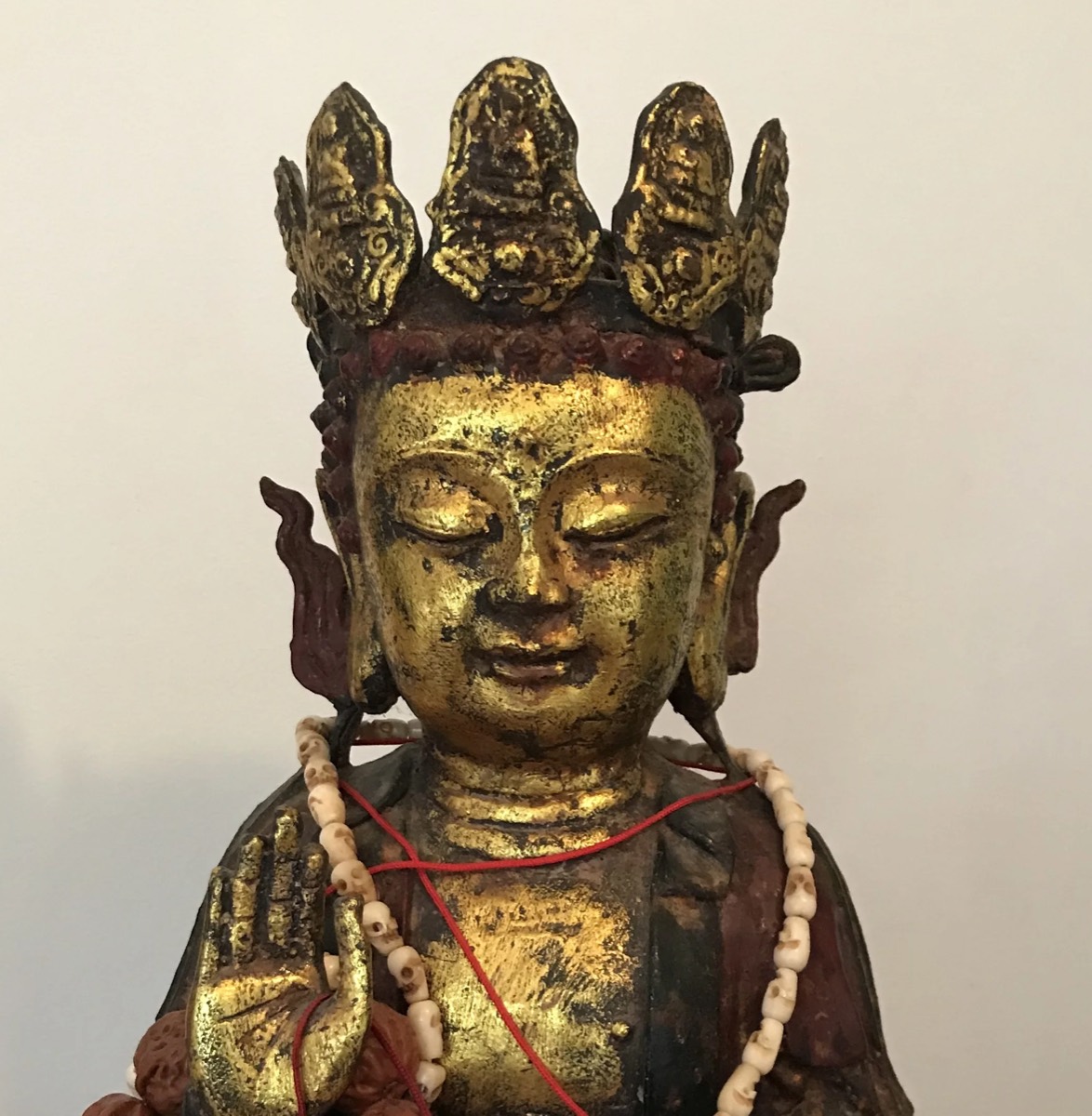 Gilt and polychrome carved wooden bodhisattva figure with bone mala